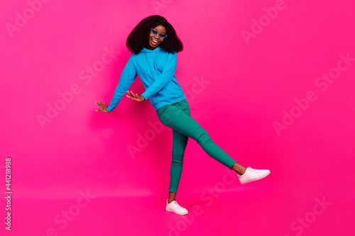 Full length photo of afro american young lady dance wear cool sunglass isolated on pink color background