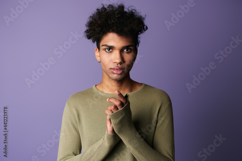 Close-up portrait of transgender african american man with afro hairstyle. Handsome boy looks camera