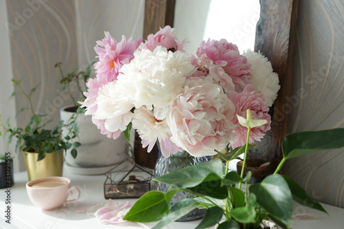 Fototapeta Naklejka Na Ścianę i Meble -  Bouquet of pink peonies on the dresser in the bedroom