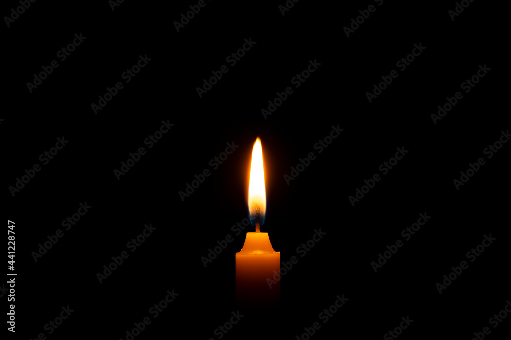Close-up of One candle burning flame on a black background - isolated, macro. Close-up of One candle burning flame on a black background - isolated, macro.