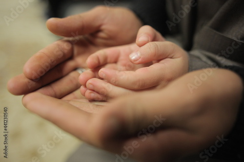 Hands of a father and his son