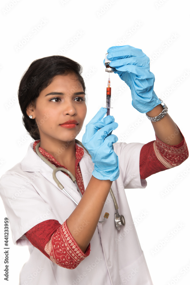 A female doctor with a stethoscope is holding an Injection or Syringe. A female doctor with a stethoscope is holding an Injection or Syringe.