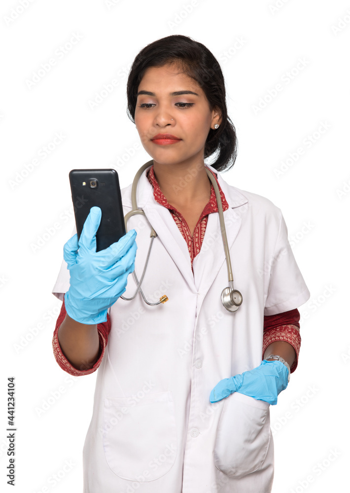 Female doctor with stethoscope talking on mobile phone on white background Female doctor with stethoscope talking on mobile phone on white background