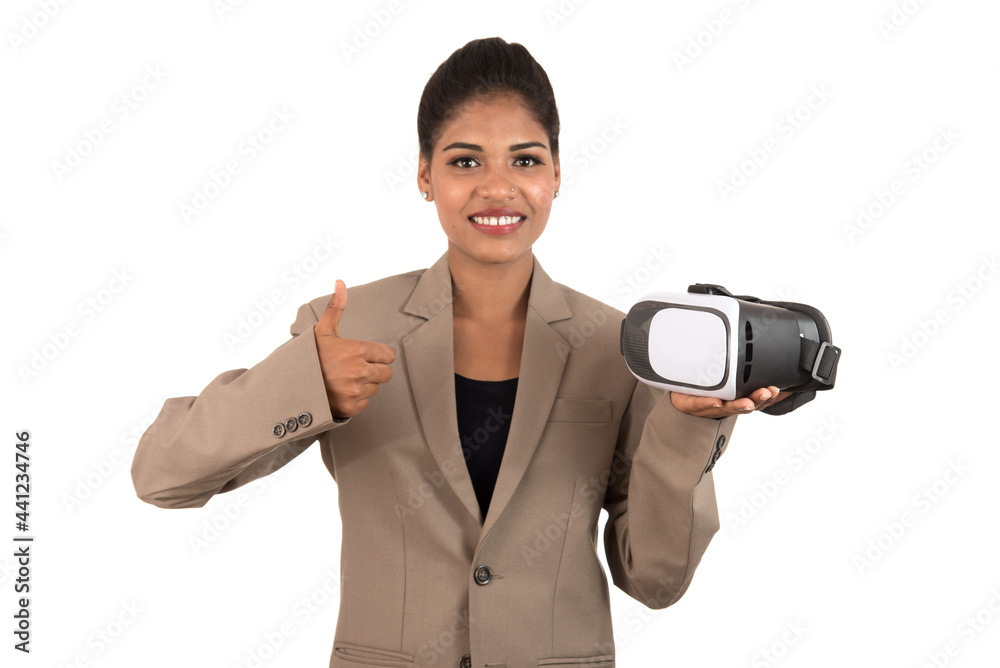 Young business woman holding & showing VR headset glasses device isolated on white background Young business woman holding & showing VR headset glasses device isolated on white background