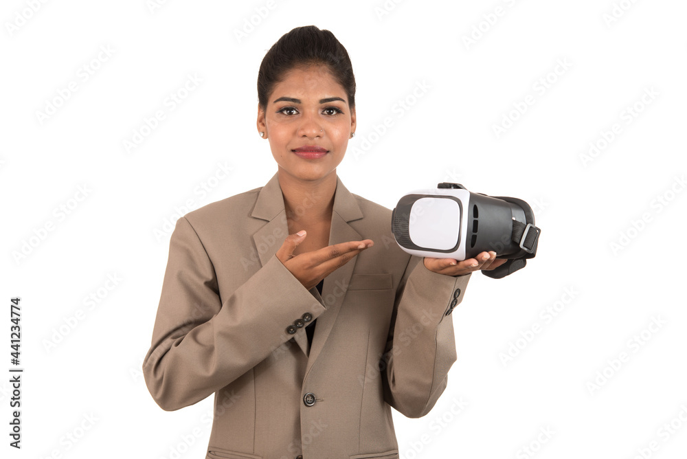 Young business woman holding & showing VR headset glasses device isolated on white background