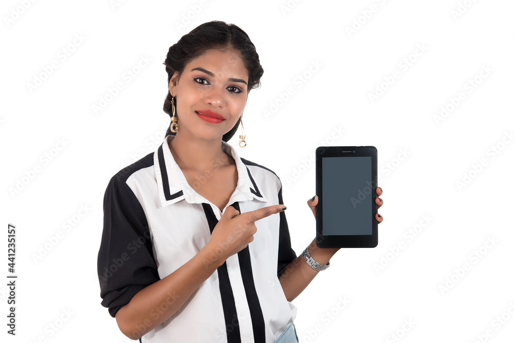 Young beautiful woman holding blank screen smart phone on white background Young beautiful woman holding blank screen smart phone on white background