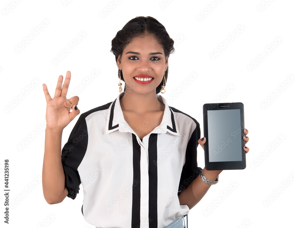 Young beautiful woman holding blank screen smart phone on white background Young beautiful woman holding blank screen smart phone on white background