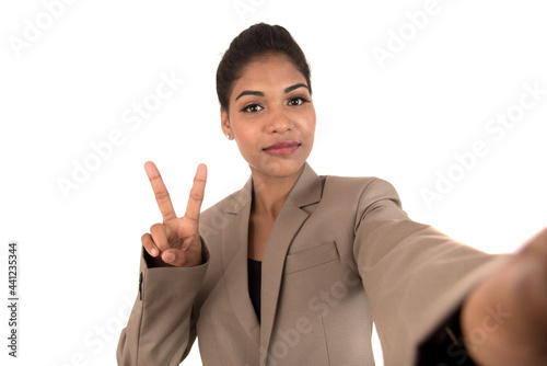 Beautiful young businesswoman using smartphone to take selfie photo isolated on white background