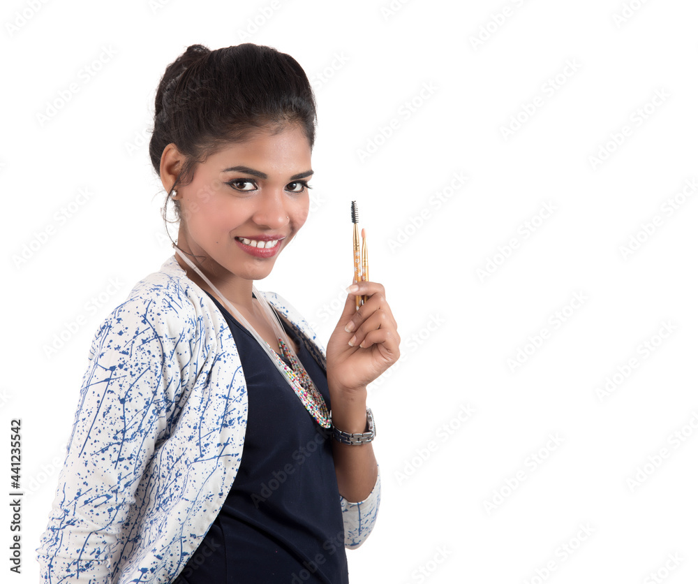 Beautiful young girl enjoying with makeup brushes isolated on white Beautiful young girl enjoying with makeup brushes isolated on white