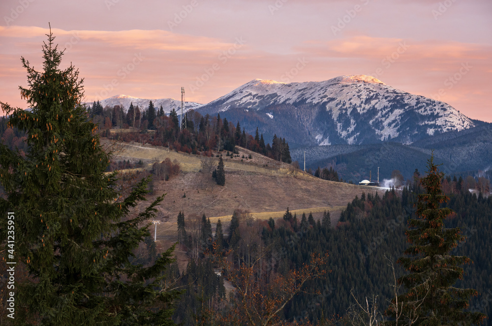 Picturesque sunrise above late autumn mountain countryside.  Ukraine, Carpathian Mountains. Peaceful traveling, seasonal, nature and countryside beauty concept scene.