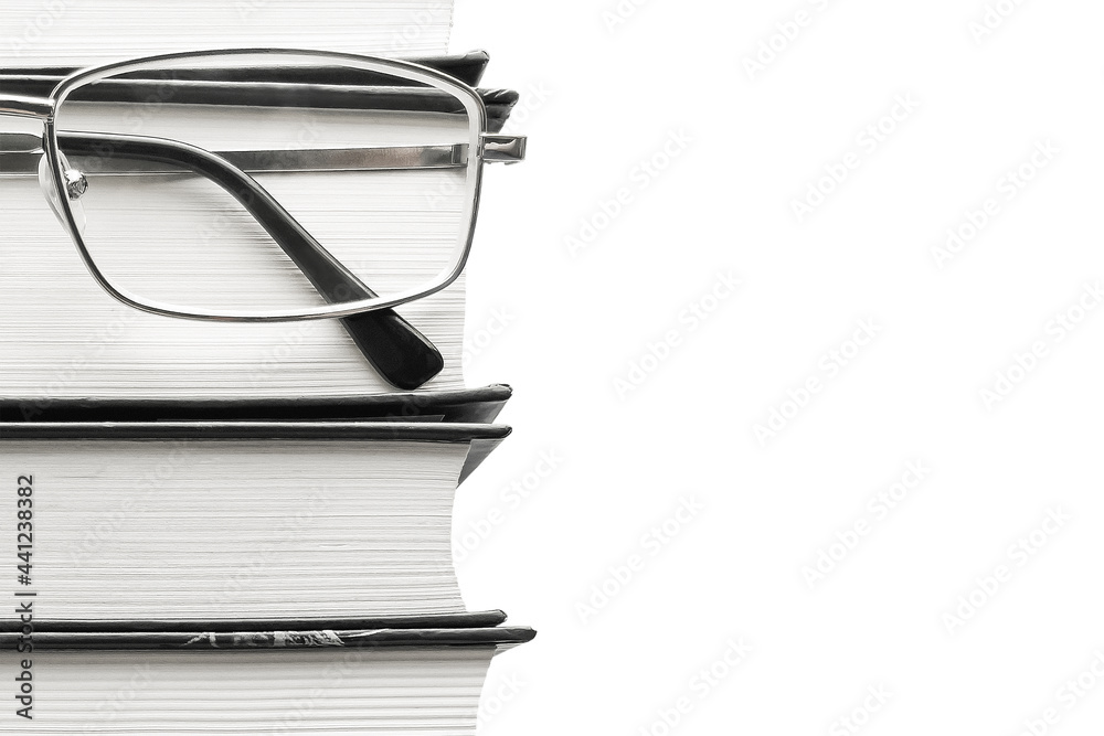 glasses and thick books on a white background. the concept of education glasses and thick books on a white background. the concept of education