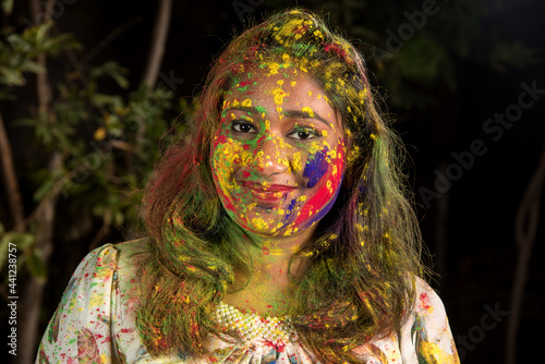Portrait of a happy young girl on the festival of colors Holi. Girl posing and celebrating the festival of colors.