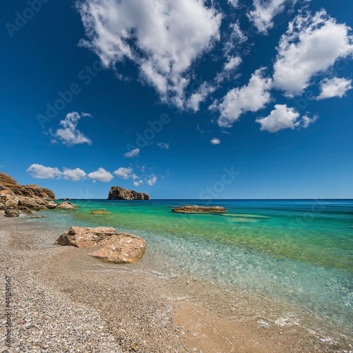 View of the beach below the cliff on the south coast of the Greek island of Amorgos in the Cyclades archipelago