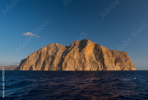 View from the sea of the impressive Mount Kalamos massif in the Greek island of Anafi in the Cyclades archipelago