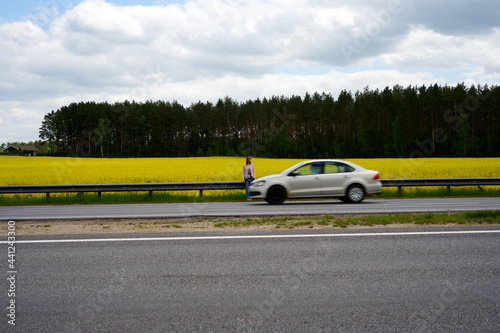 Photo of tall woman on road in field with auto posing