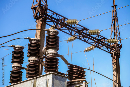 Power transmission tower with electric garland of insulators on transformer station photo