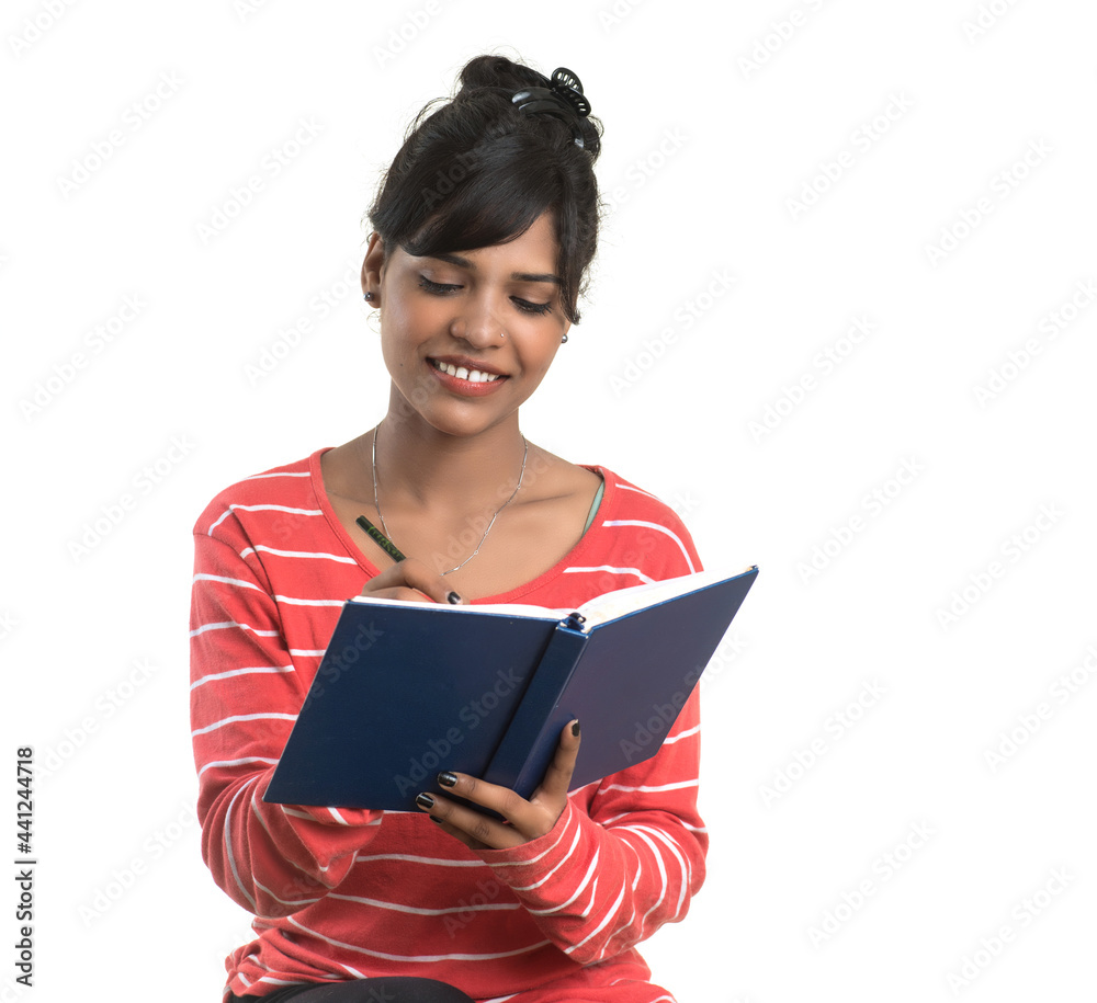 Pretty young girl holding book and posing on white background Pretty young girl holding book and posing on white background