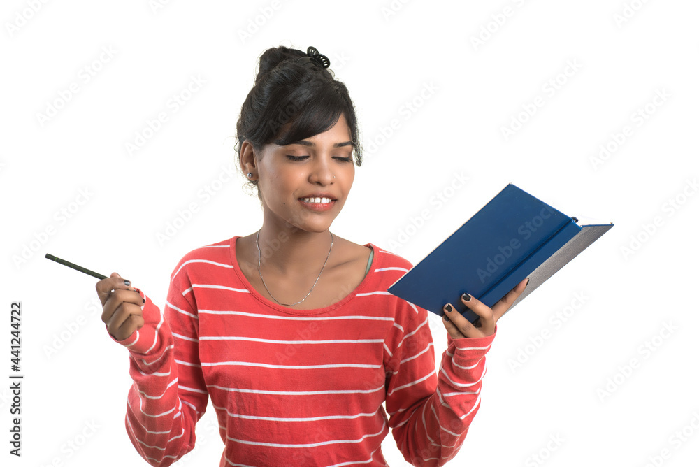 Pretty young girl holding book and posing on white background Pretty young girl holding book and posing on white background