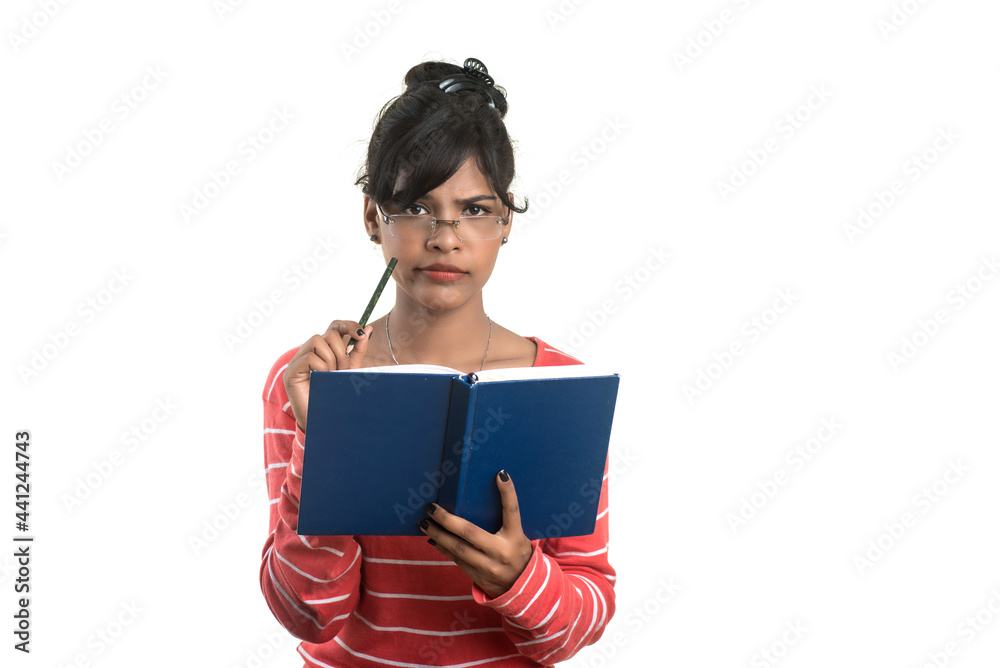 Pretty young girl holding book and posing on white background Pretty young girl holding book and posing on white background