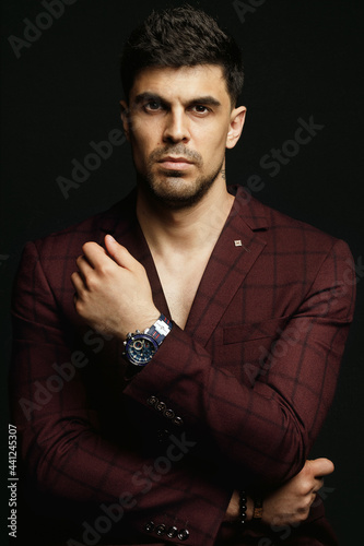 smart casual man, close up head shot confident serious concentrated man looking at camera studio portrait, isolated on black studio background.