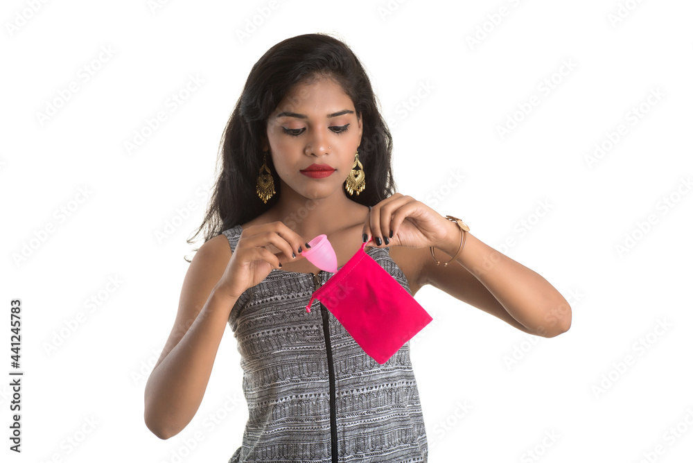 Close-up of young girl hands holding menstrual cup, Gynaecology concept, Showing thumbs up approving the use of the menstrual cup Close-up of young girl hands holding menstrual cup, Gynaecology concept, Showing thumbs up approving the use of the menstrual cup