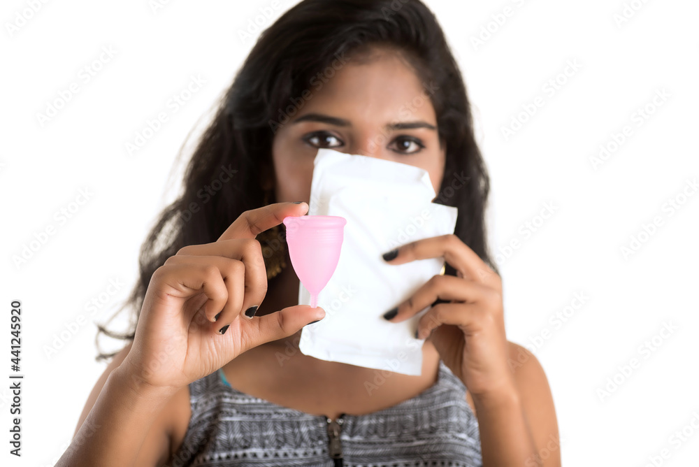 Close-up of young girl hands holding menstrual cup, Gynaecology concept, Showing thumbs up approving the use of the menstrual cup Close-up of young girl hands holding menstrual cup, Gynaecology concept, Showing thumbs up approving the use of the menstrual cup