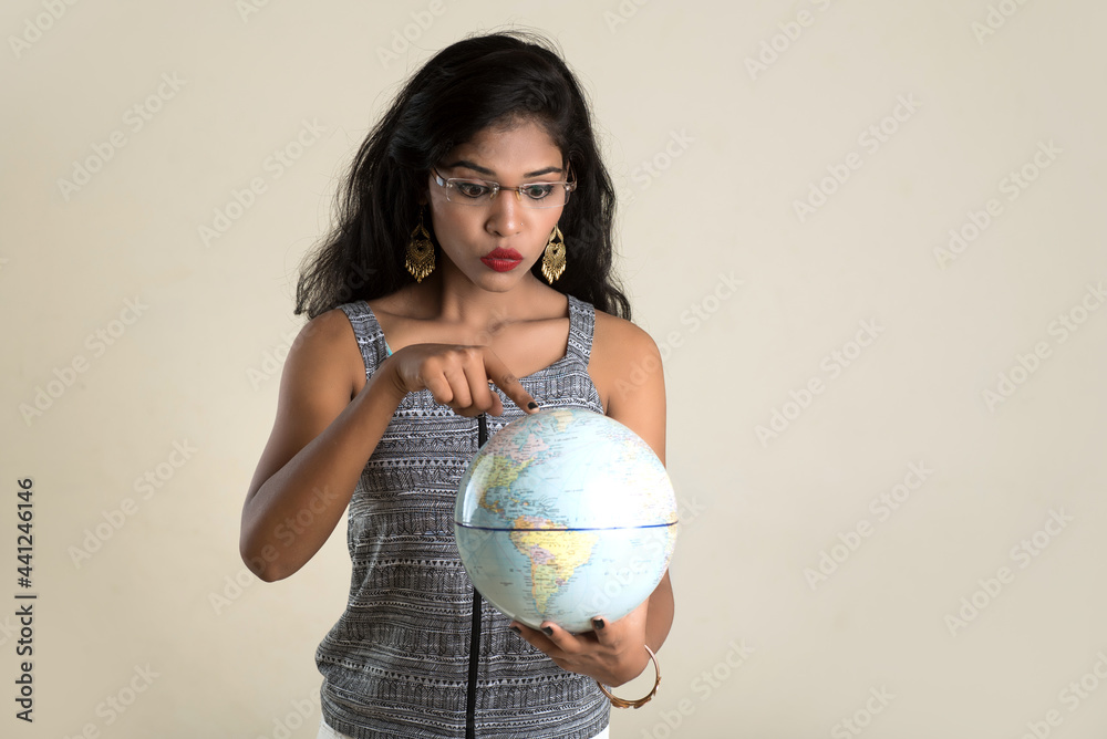 Portrait of young Girl holding and posing with a world globe. Portrait of young Girl holding and posing with a world globe.