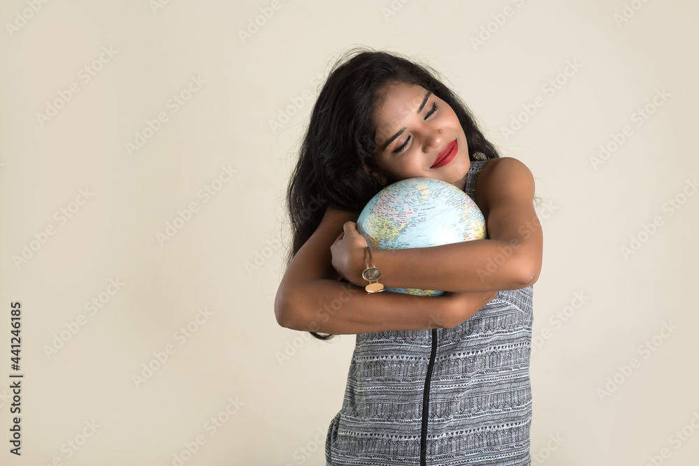 Portrait of young Girl holding and posing with a world globe. Portrait of young Girl holding and posing with a world globe.