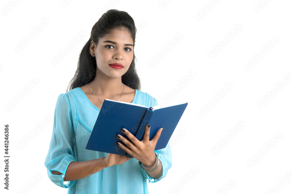 Pretty young girl holding book and posing on white background Pretty young girl holding book and posing on white background