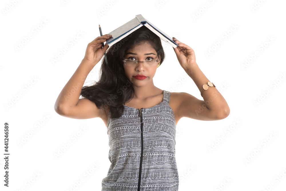 Pretty young girl holding book and posing on white background Pretty young girl holding book and posing on white background