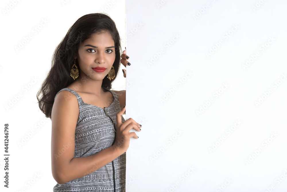 Beautiful young Girl holding white big signboard and posing Beautiful young Girl holding white big signboard and posing