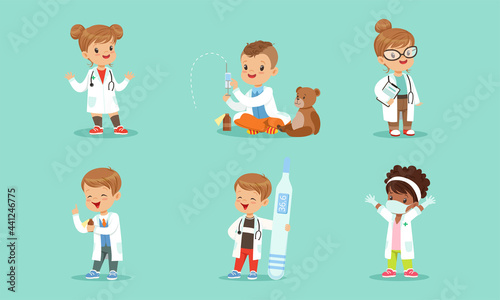 Set of Cute Kids in White Coats Playing Doctors, Cheerful Little Boys and Girls Examining and Treating their Patients with Medical Tools Cartoon Vector Illustration