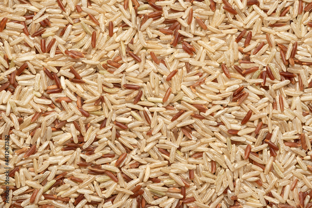 mix of brown and red rice. food background, texture