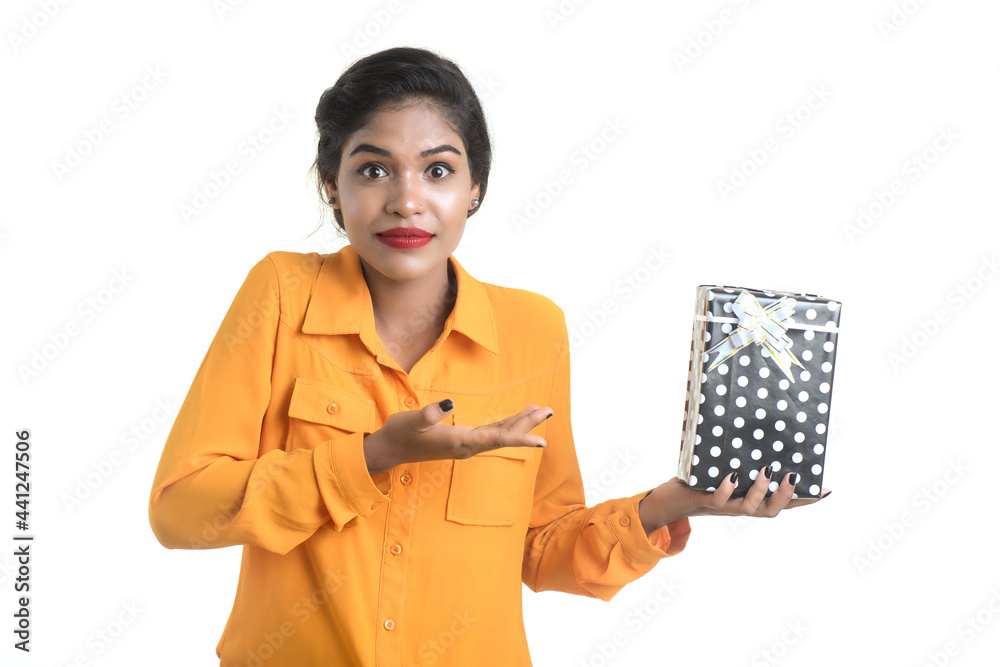 Portrait of young happy smiling Indian Girl holding gift boxes on a white background. Portrait of young happy smiling Indian Girl holding gift boxes on a white background.