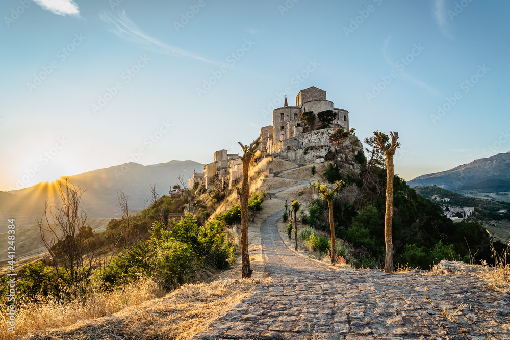 Stone village of Petralia Soprana,the highest village in Madonie mountain range,Sicily,Italy.Church of Santa Maria di Loreto at sunset.Picturesque stone houses,narrow cobbled streets,views of town