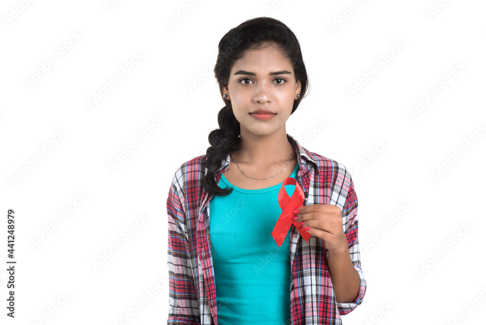 Young woman showing red ribbon HIV, AIDS awareness ribbon, healthcare and medicine concept Young woman showing red ribbon HIV, AIDS awareness ribbon, healthcare and medicine concept