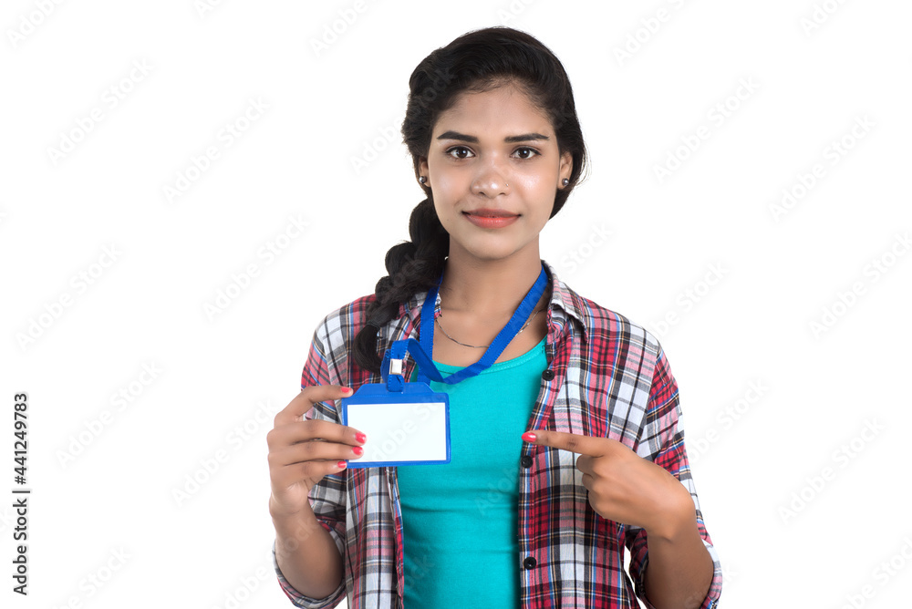 Young woman holding Identification white blank plastic id card. Young woman holding Identification white blank plastic id card.