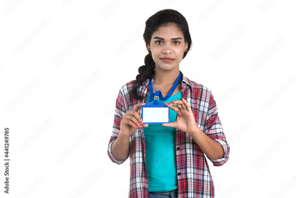 Young woman holding Identification white blank plastic id card. Young woman holding Identification white blank plastic id card.
