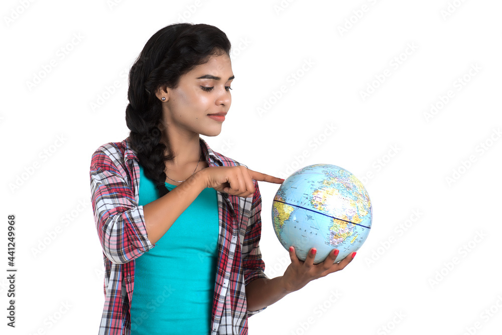 young woman holding the world globe and posing on a white background. young woman holding the world globe and posing on a white background.