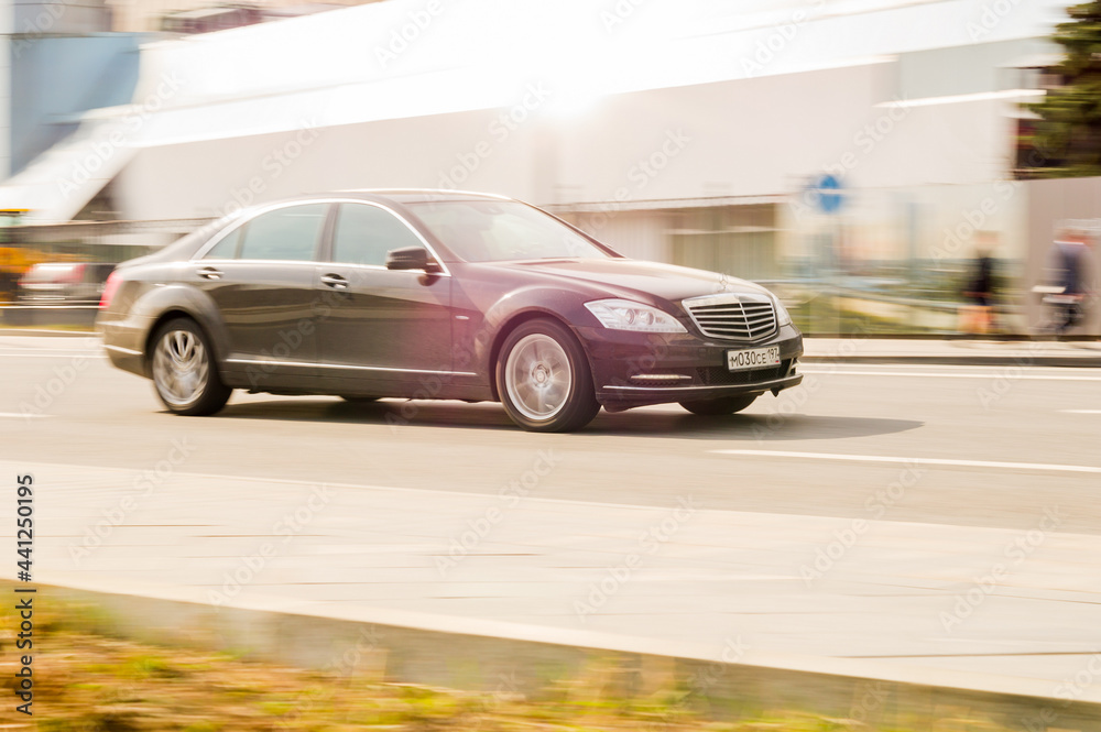 MercedesBenz SClass W221 at the city road in motion. Black car