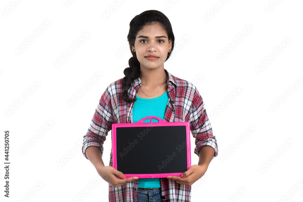 Beautiful young girl holding or posing with a chalkboard slate on a white background Beautiful young girl holding or posing with a chalkboard slate on a white background