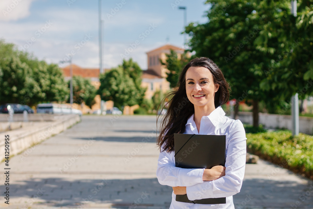 Fototapeta premium Happy adult student poses looking at camera on college campus.Senior and street student concept.