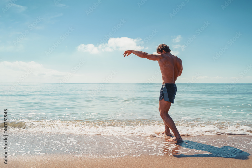A muay thai or kickboxer training with shadow boxing outdoor at seashore A muay thai or kickboxer training with shadow boxing outdoor at seashore