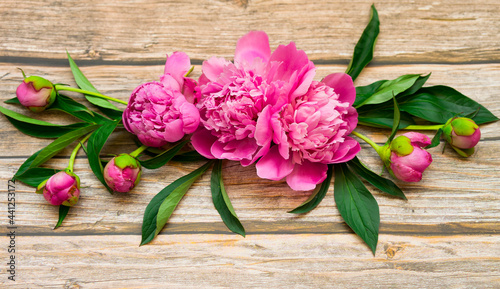 Bouquet of pink peonies on a wooden background © SEA_Ekaterina