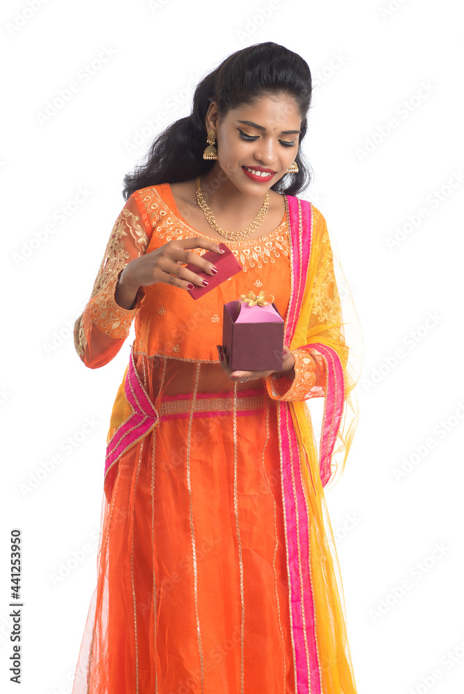 Portrait of young happy smiling Indian Girl holding gift boxes on a white background. Portrait of young happy smiling Indian Girl holding gift boxes on a white background.