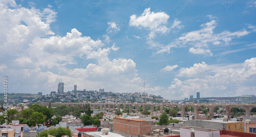 queretaro mexico city landscape photography, mexican city, queretearo aqueduct view, buildings, houses, blue sky with clouds
