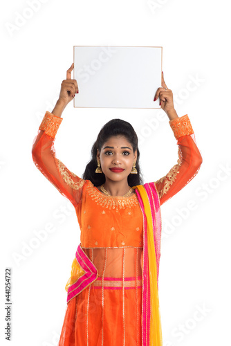 Traditional Girl holding and showing blank white sign board