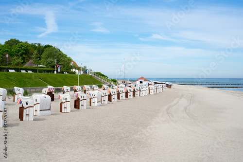 Wide beach in Kuehlungsborn on the Baltic Sea, Mecklenburg Western Pomerania. Blue sky, beach chairs and the promenade, a great view