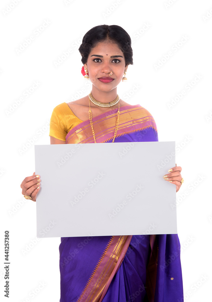 Traditional Girl holding and showing blank white sign board Traditional Girl holding and showing blank white sign board