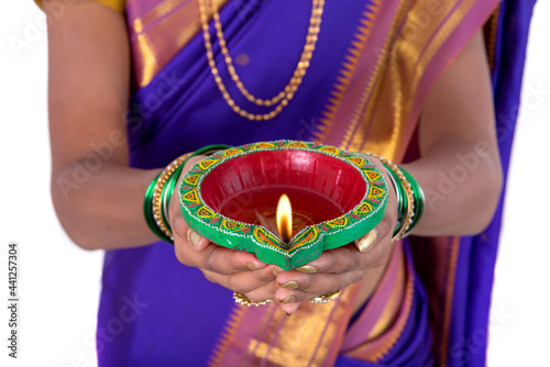 Photography Portrait of a woman holding diya, Diwali or deepavali photo with female hands ho